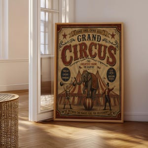 May include: A framed vintage-style circus poster featuring an elephant balancing on a ball, a strongman lifting weights, and a ringmaster. The text reads "COME ONE, COME ALL! GRAND CIRCUS THE GREATEST SHOW ON EARTH!" with additional decorative circus graphics.