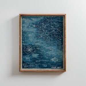 Puede incluir: Una impresión enmarcada de un mapa estelar vintage en azul y blanco. El mapa presenta constelaciones y detalles celestes, con las palabras "Starry Night" en la parte inferior. El marco de madera añade un toque clásico a esta obra de arte con temática astronómica.