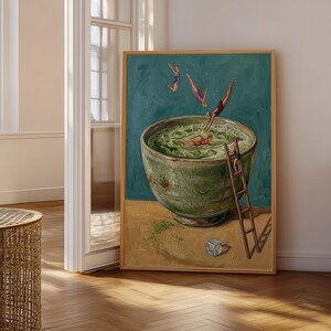 May include: A framed wall art print depicting a large, textured green bowl filled with liquid and ice cubes. Several small figures are shown diving into the bowl, swimming, or climbing a wooden ladder leaning against the side of the bowl.