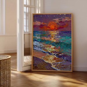 May include: A framed mosaic artwork showing a sunset over the sea. The artwork uses a vibrant palette of orange, purple, blue, and yellow. The mosaic is framed in light-coloured wood and leans against a white wall.