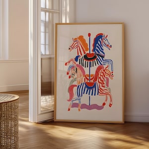 May include: A framed art print depicting a carousel with horses in vibrant colours. The horses have striped and patterned coats in red, blue, orange, and pink. The artwork is displayed in a room with natural light.