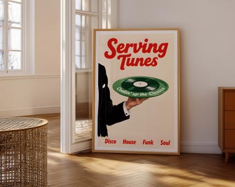May include: A framed poster with the words "Serving Tunes" in red. A hand in a black suit holds a green vinyl record. Below the record are the words "Disco House Funk Soul". The poster is in a room with a wooden floor.