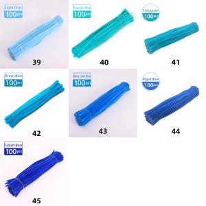May include: A selection of blue pipe cleaner bundles, each with 100 pieces, in shades such as light blue, peacock blue, turquoise, ocean blue, deep lake blue, royal blue, and cobalt blue. Each bundle is secured with a rubber band. Numbers 39, 40, 41, 42, 43, 44, and 45 are visible.