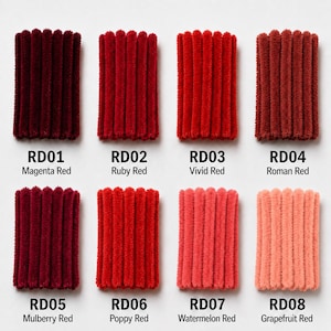 May include: Eight rectangular swatches of fuzzy, ribbed chenille yarn arranged in two rows. Each swatch is labeled with a code and color name: RD01 Magenta Red, RD02 Ruby Red, RD03 Vivid Red, RD04 Roman Red, RD05 Mulberry Red, RD06 Poppy Red, RD07 Watermelon Red, and RD08 Grapefruit Red.