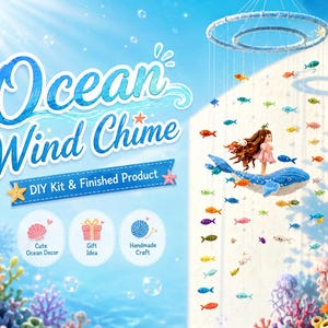 May include: A mobile wind chime featuring a blue whale and a small figure with long brown hair, suspended from two circular rings. Numerous small, colorful fish hang from strings. The text reads Ocean Wind Chime, DIY Kit & Finished Product.