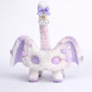 May include: A set of three ceramic mugs with a speckled, matte finish. The mugs are in shades of cream, light gray, and dark gray. Each mug has a simple, minimalist design, perfect for coffee or tea.