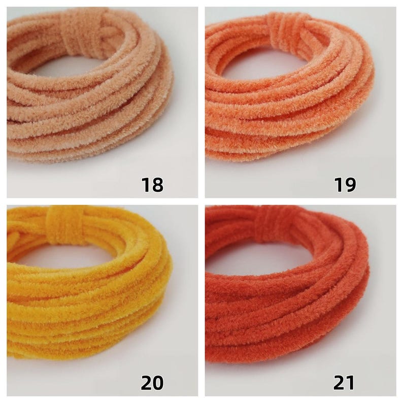May include: Four colourful scrunchies in peach, orange, yellow, and red-orange. Each scrunchie is a circular shape with a ribbed texture. Numbers 18, 19, 20, and 21 are printed below each scrunchie.