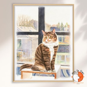 May include: A watercolor painting of a brown tabby cat with white chest fur sitting on a ledge in front of a window. The cat has yellow eyes and is looking to the side. The artwork is framed in a light wood frame with a logo in the corner.