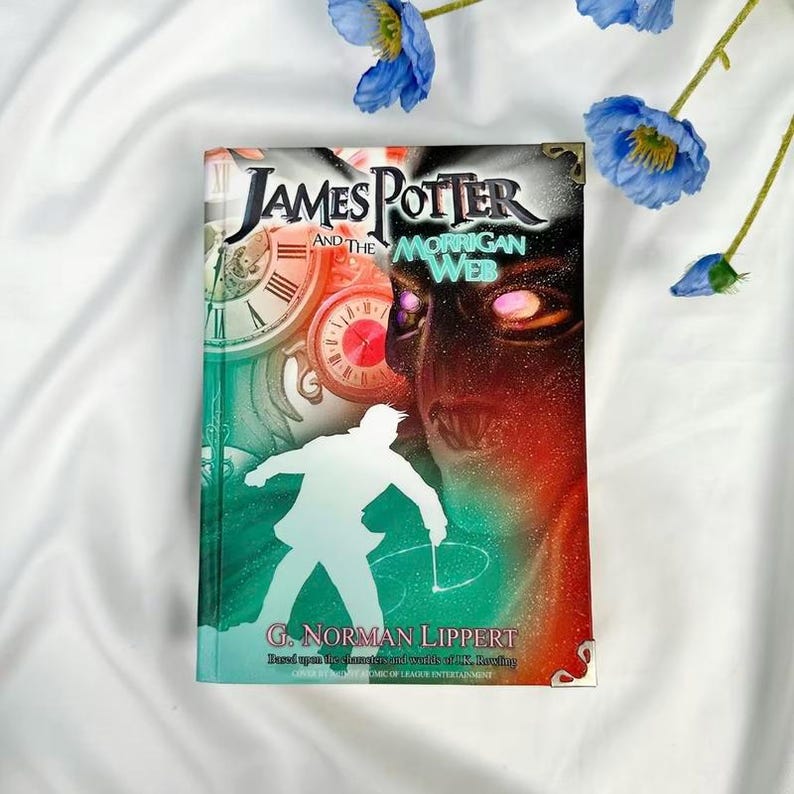 May include: A hardcover book titled "James Potter and the Morrigan Web" with a green, red, and black cover. The cover features a silhouette of a person, clocks, and the author's name, G. Norman Lippert. Blue flowers are in the background.