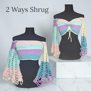 May include: Two off-the-shoulder crochet shrugs in pastel colors, displayed on black mannequins. The shrugs feature a mix of pink, blue, green, and purple stripes, with bell sleeves. The text "2 Ways Shrug" is at the top.