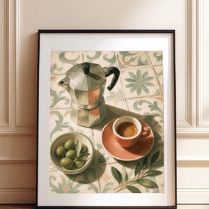 May include: A framed wall art print depicting a silver moka pot, a small terracotta-colored espresso cup on a matching saucer, and a bowl of green olives. The scene is set on a surface with a light-colored tile pattern featuring floral motifs.