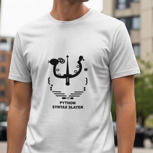 May include: White t-shirt with a black graphic design and the text "PYTHON SYNTAX SLAYER". The design features a stylized trident and other symbols. The shirt is being worn by a person.