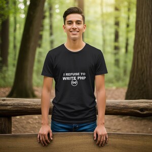 May include: Black t-shirt with the text "I REFUSE TO WRITE PHP" in white, along with a stylized PHP logo. The shirt is worn by a person in a natural outdoor setting.