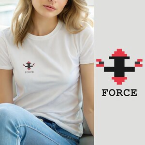 May include: A white short-sleeved t-shirt featuring a small pixelated graphic on the chest. The design consists of a black and red cross-like shape with a pixelated aesthetic, positioned above the word FORCE printed in a bold black serif font.