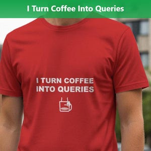 May include: A red t-shirt with the text "I TURN COFFEE INTO QUERIES" in white, along with a small coffee cup graphic. The shirt is short-sleeved and appears to be made of a soft material.