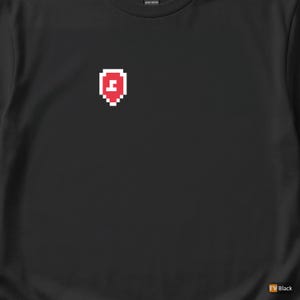 May include: Black t-shirt with a pixelated red and white shield design on the upper left chest. The shield has a white letter "J" inside. The shirt is made of heavy cotton.