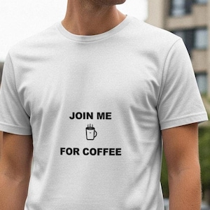 May include: White t-shirt with the text "JOIN ME FOR COFFEE" in black, featuring a coffee cup graphic. The shirt is a simple crew neck style.