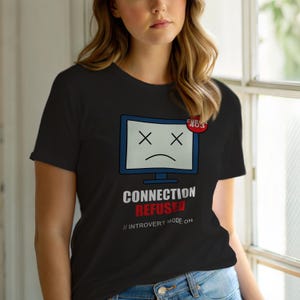 May include: Black t-shirt with a computer screen graphic showing a sad face and the text "CONNECTION REFUSED // INTROVERT MODE ON." A red circle with "ERROR 403" is in the top right corner.
