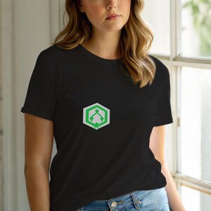 May include: Black t-shirt with a green and white geometric design on the chest. The design is a hexagon with a stylized tree graphic inside. The shirt is short-sleeved and made of a soft material.