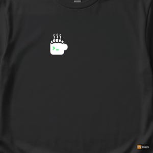 Op de afbeelding: Zwart T-shirt met een witte koffiekop-afbeelding, stoom en een groen commandopromptsymbool. Het ontwerp staat op de linkerbovenborst. Het shirt is gemaakt van zwaar katoen.