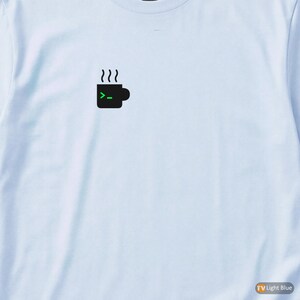 May include: Light blue long-sleeve shirt with a small black graphic of a coffee mug with steam and a green command prompt symbol. The shirt is made of a soft material.