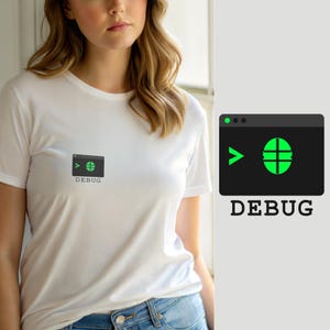 May include: A white short-sleeved t-shirt featuring a small graphic on the chest. The graphic displays a dark gray rectangular window with a green greater-than symbol, a green circular icon with a crosshair, and the word DEBUG printed below.