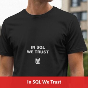 May include: Black t-shirt with the text "IN SQL WE TRUST" in white, along with a white graphic of a database symbol. The shirt is short-sleeved and appears to be made of a soft material.