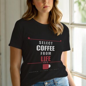 May include: Black t-shirt with the text "SELECT COFFEE FROM LIFE" in white and red. A red coffee cup graphic is below the text. The shirt has a crew neck and short sleeves.