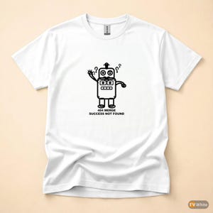May include: White t-shirt featuring a black cartoon robot design. The robot has a box-shaped body, two eyes, and question marks above its head. The text "404 MERGE SUCCESS NOT FOUND" is printed below the robot.