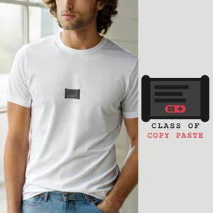 May include: A white short-sleeved t-shirt featuring a small graphic on the chest. The graphic depicts a dark grey rectangular icon with three horizontal lines and a red button with a minus and plus sign. Below it is the text CLASS OF COPY PASTE.