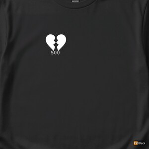 May include: Black t-shirt with a white graphic of a broken heart and the number "500" below it. The shirt is made of heavy cotton.