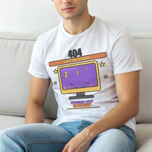May include: White t-shirt with a humorous graphic featuring a computer monitor with a smiling face and the text "404 Sleep Not Found." The design includes stars and the phrase "Debugging Since Midnight."