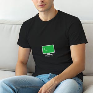 May include: Black t-shirt with a green computer screen graphic and the word "REBOOT" below. The computer screen shows a dollar sign and an underscore. The t-shirt is made of a soft material.