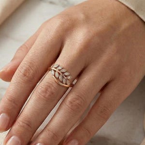 May include: A trio of ceramic mugs with a speckled, matte finish in cream, light grey, and dark grey. Each mug features a simple, minimalist design, ideal for tea or coffee.