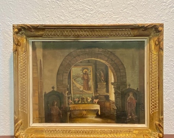 May include: An oil painting in a decorative gold-toned frame depicting a church interior with a stone archway, an altar, and religious figures. The artwork features muted earth tones and includes a signature and the year 1956 in the bottom left corner.