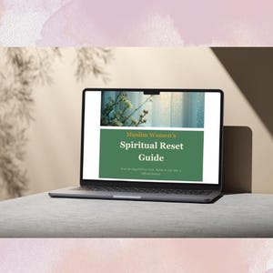 May include: A laptop displaying a webpage titled "Muslim Women's Spiritual Reset Guide." The screen shows a green banner with white text. The laptop is open on a light gray surface, with a soft, neutral background.