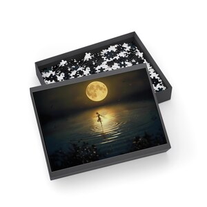 May include: A jigsaw puzzle with a serene image of a figure dancing on water under a full moon. The puzzle box is open, revealing the completed image and scattered puzzle pieces. The color palette includes shades of blue, yellow, and black.