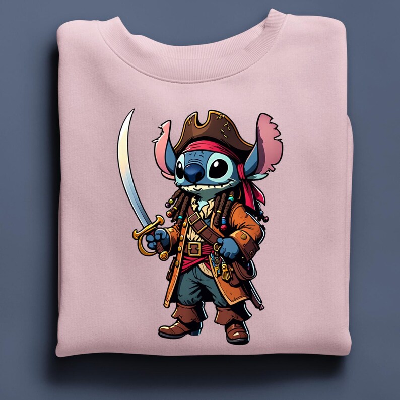 May include: A light pink sweatshirt featuring a cartoon illustration of Stitch dressed as a pirate. Stitch is blue with large eyes, wearing a brown pirate hat, jacket, and holding a sword. The design is centered on the folded sweatshirt.
