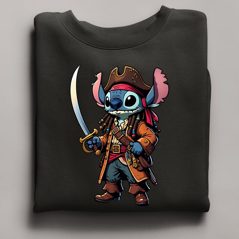 May include: Black sweatshirt featuring a cartoon character dressed as a pirate. The character is blue with large ears, wearing a brown pirate hat, coat, and boots, and holding a sword. The design is detailed with gold accents and a red bandana.