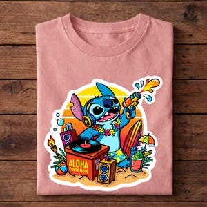 May include: A light pink t-shirt featuring a cartoon character, Stitch, holding a water gun. The design includes a turntable, surfboard, and the text "ALOHA PARTY MODE". The background has a sunset design.