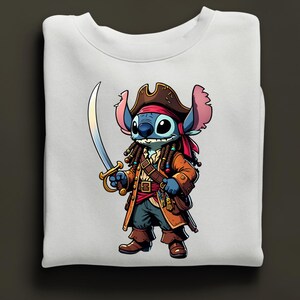May include: White sweatshirt featuring a cartoon character dressed as a pirate. The character is blue with large ears, wearing a brown pirate hat, coat, and holding a sword. The design is centered on the front of the sweatshirt.