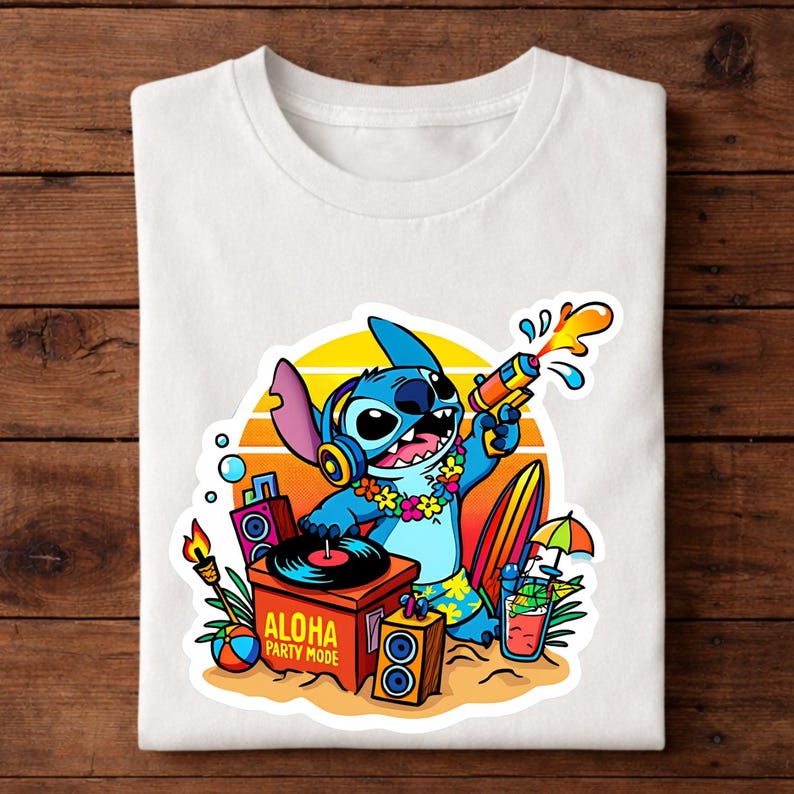 May include: White t-shirt featuring a cartoon character, Stitch, holding a water gun. Stitch is wearing headphones and a floral lei. The design includes a sunset, surfboard, and the text "ALOHA PARTY MODE".