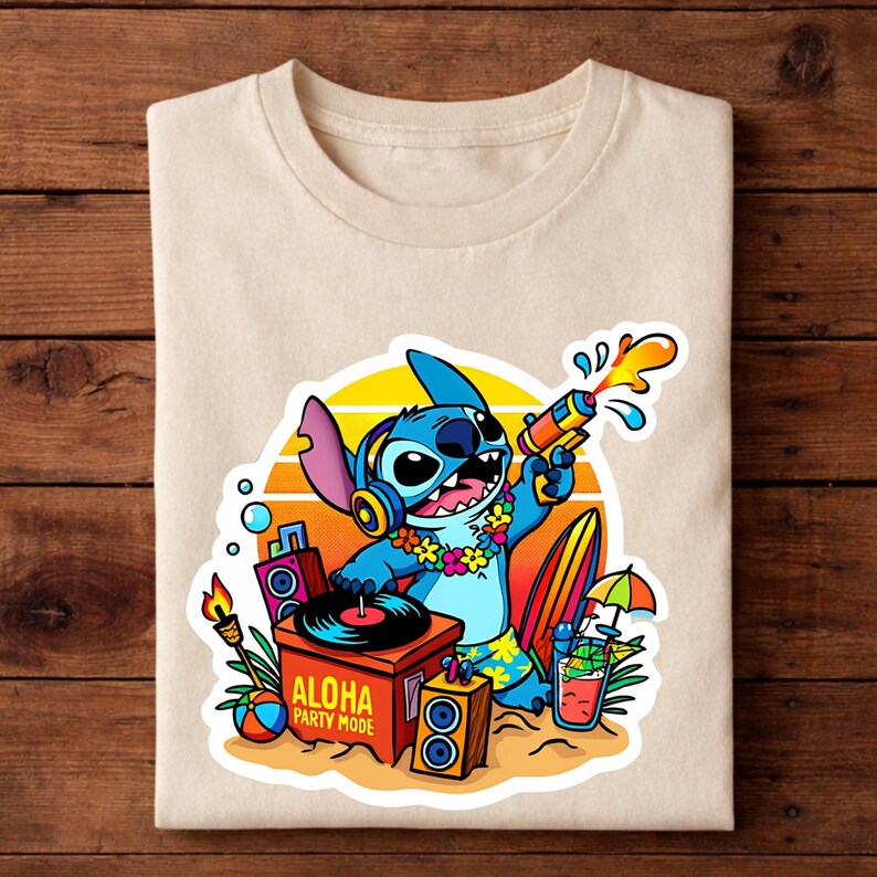 May include: Beige t-shirt featuring a colorful graphic of the character Stitch from Lilo & Stitch. Stitch is holding a water gun, wearing headphones and a lei, with the text "ALOHA PARTY MODE". The design includes a surfboard, cocktail, and a DJ setup.