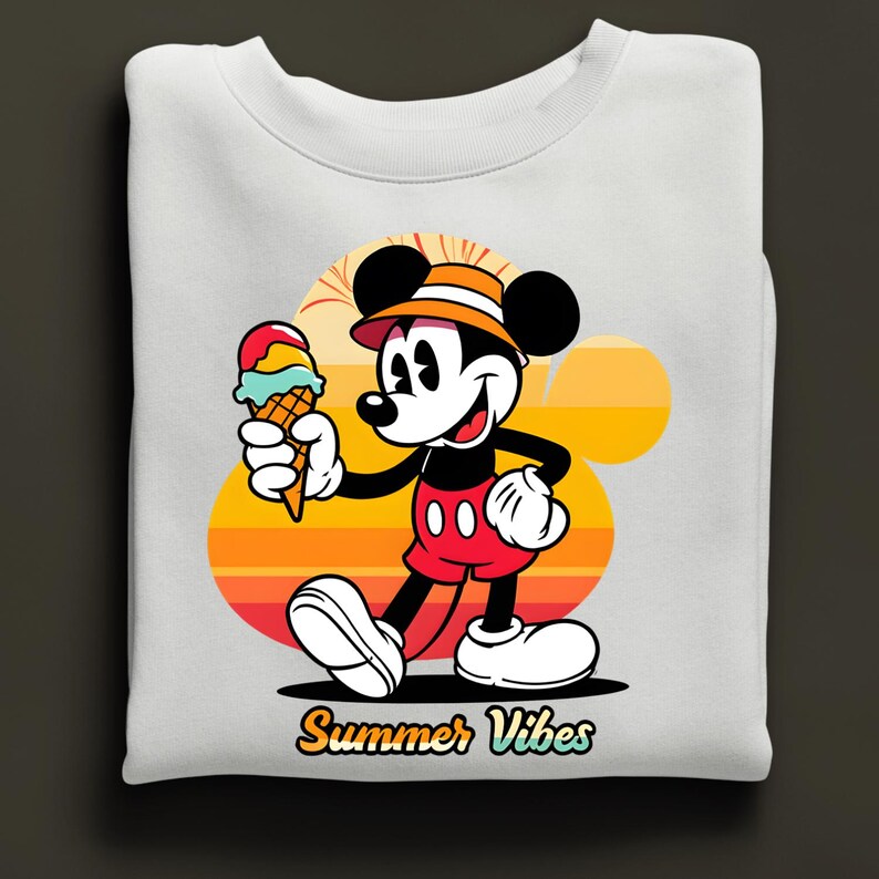 May include: White sweatshirt featuring a cartoon Mickey Mouse holding an ice cream cone. Mickey is wearing a hat and red shorts. The background has a sunset design with the words "Summer Vibes".