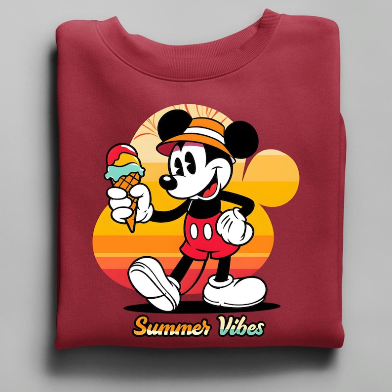 May include: Maroon sweatshirt featuring a cartoon Mickey Mouse holding a colorful ice cream cone. Mickey is wearing a hat, red shorts, and white gloves and shoes. The background has a sunset design with the words "Summer Vibes" in yellow.