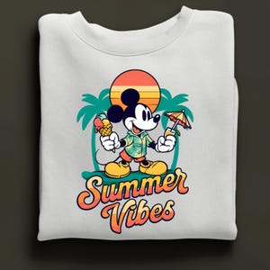 May include: White sweatshirt featuring a cartoon Mickey Mouse design. Mickey is holding an ice cream cone and a tropical drink, with a sunset and palm trees in the background. The words "Summer Vibes" are written in a retro font.