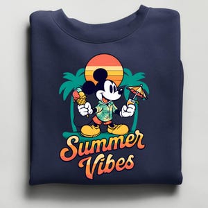 May include: Navy blue sweatshirt featuring Mickey Mouse holding an ice cream cone and a tropical drink. The graphic includes a sunset, palm trees, and the words "Summer Vibes" in orange and yellow.