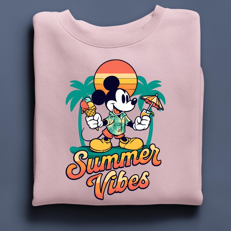May include: A light pink sweatshirt featuring a cartoon Mickey Mouse design. Mickey is holding an ice cream cone and a tropical drink. The design includes a sunset, palm trees, and the words "Summer Vibes" in orange and yellow.