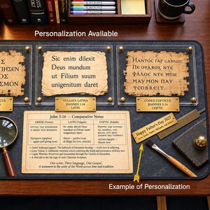 May include: A desk mat featuring three framed parchment-style prints with Greek, Latin, and Coptic text from John 3:16, accompanied by a comparative notes chart, a magnifying glass, a paintbrush, a ruler, and a personalized brass plaque.