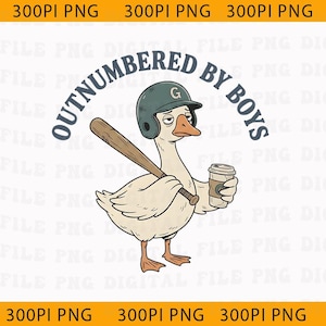 May include: A cartoon illustration of a goose wearing a baseball helmet and holding a bat and coffee cup. The text "OUTNUMBERED BY BOYS" is arched above the goose.